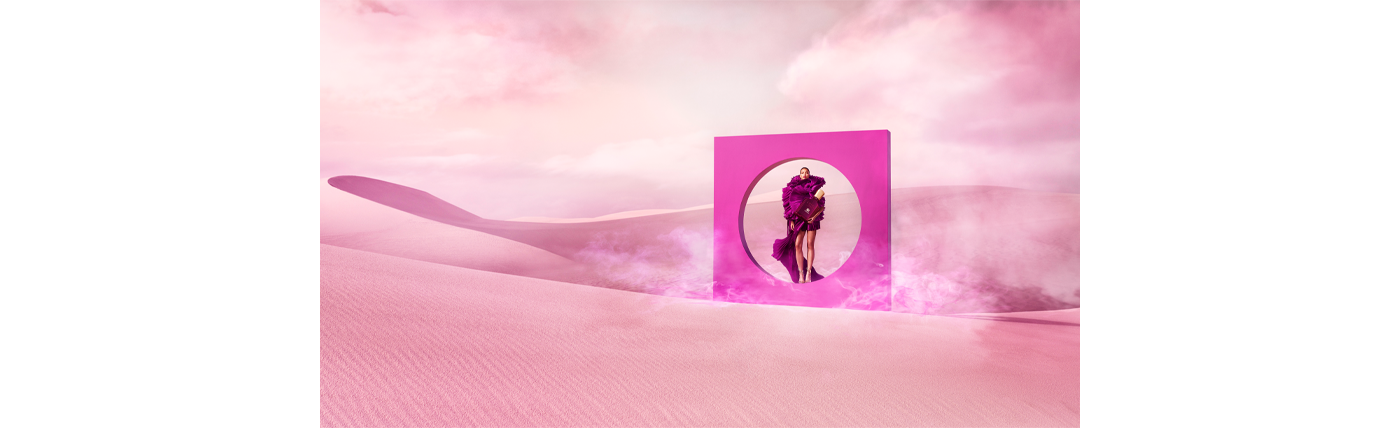Woman wearing pink dress in desert holding Carmina