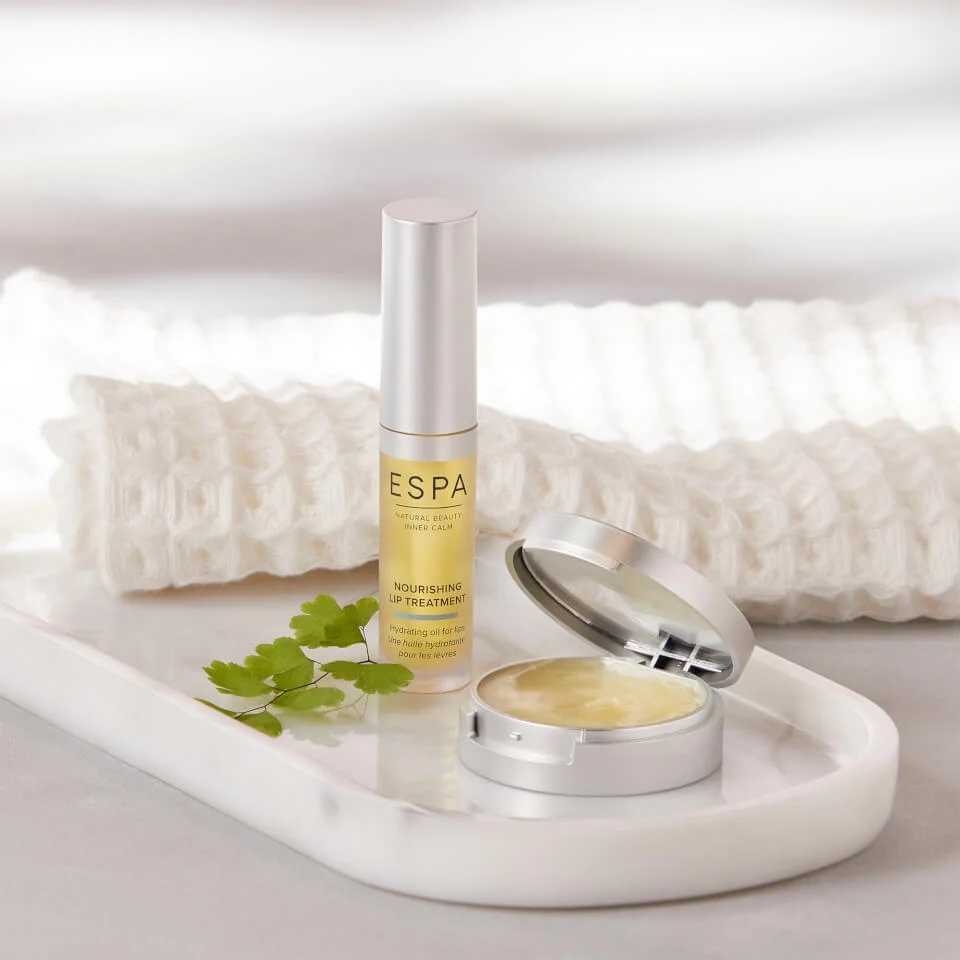 a silver and yellow tube of the ESPA Nourishing Lip Treatment 5ml. On the tube, it says: ESPA, NATURAL BEAUTY, INNER CALM, NOURISHING LIP TREATMENT, Hydrating oil for lips, Une huile hydratante pour les levres
