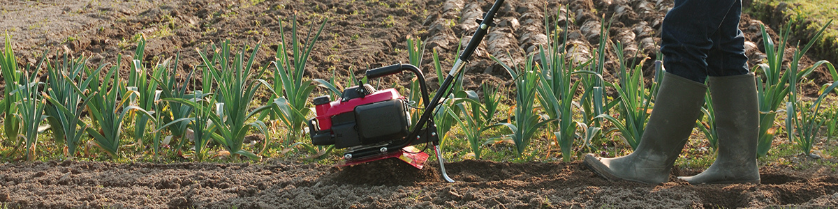 Tiller being used on soil