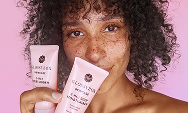 model holding GLOSSYBOX Skincare products