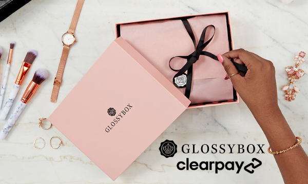 Pink GLOSSYBOX on white marble background, with GLOSSYBOX and Clearpay logo.