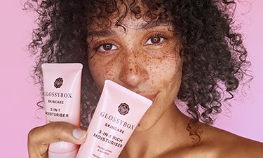 model holding glossybox skincare products