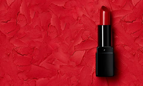 Illamasqua red lipstick on background of crushed matte red lipstick