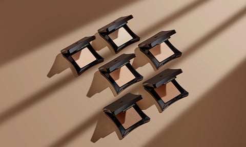 Skin Base Pressed Powders on tan background.