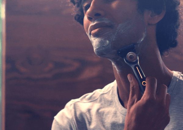 Man holding Gillette Labs Heated Razor with Gillette Shaving Foam around face | Gillette UK