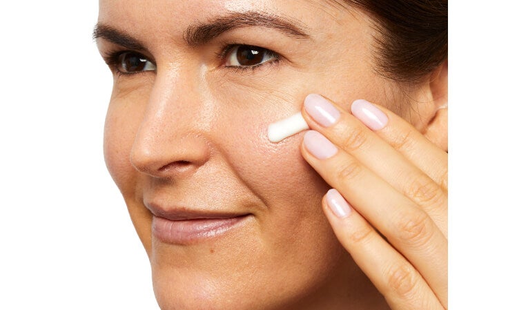 Woman applying Retinol product