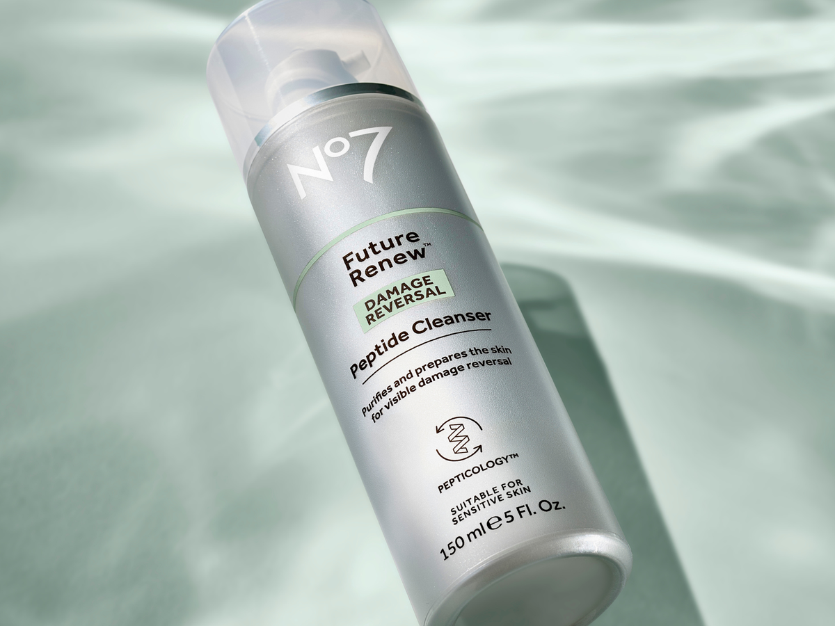 No7 Future Renew Peptide Cleanser on a green background with the reflections of water visible
