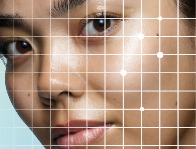 Close up photo of a model to show the glass skin look. Subtle grid over the face indicates getting a skin analysis