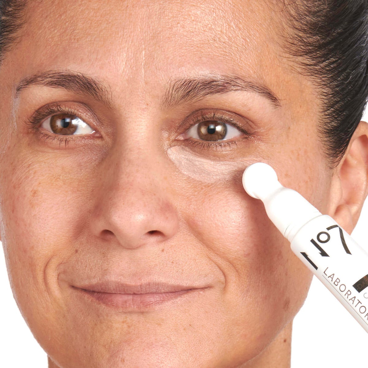 Woman applying No7 Laboratories Dark Circle Corrector under her eye