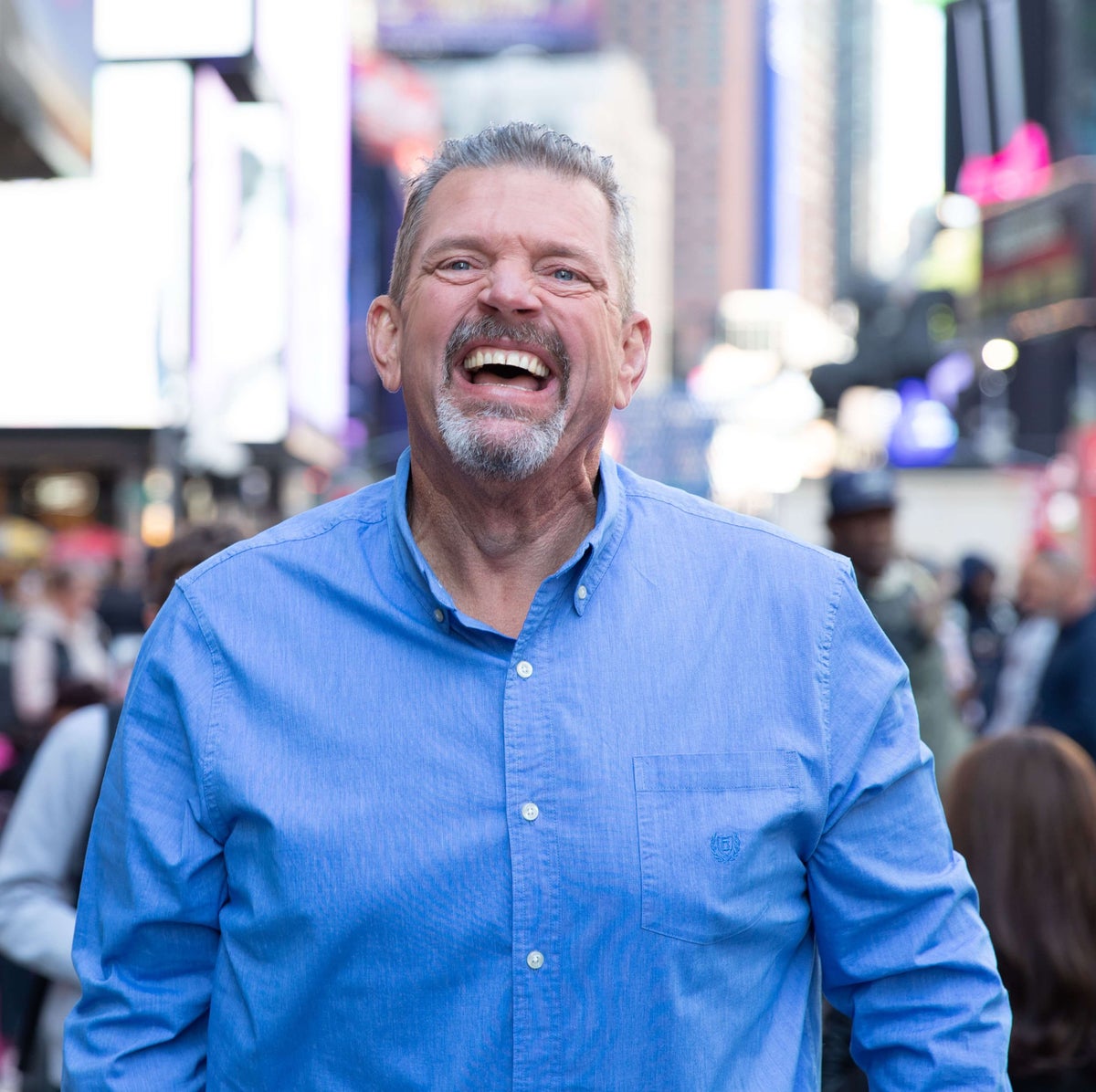Image of a man laughing in a city