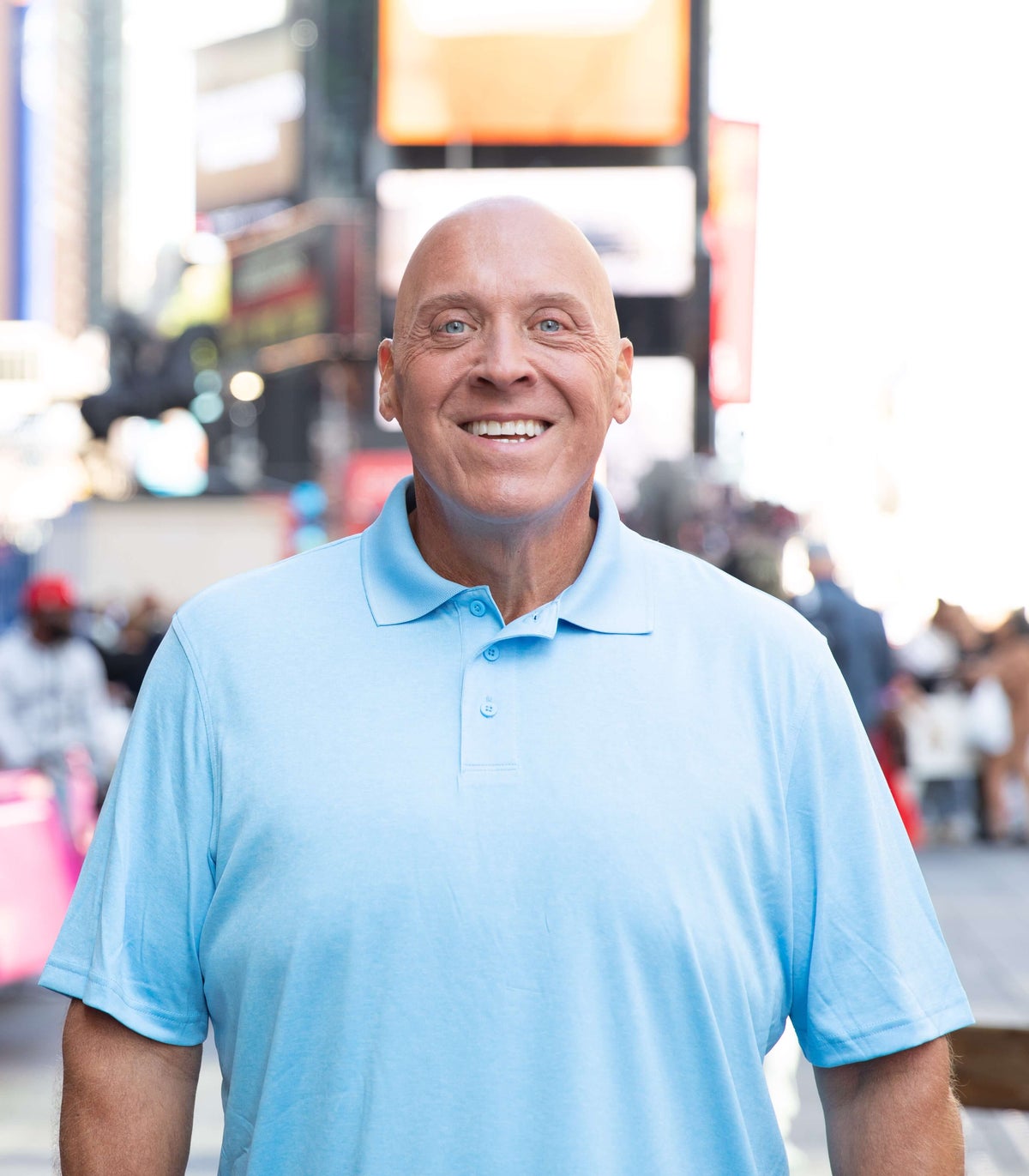 Image of a man smiling in a city