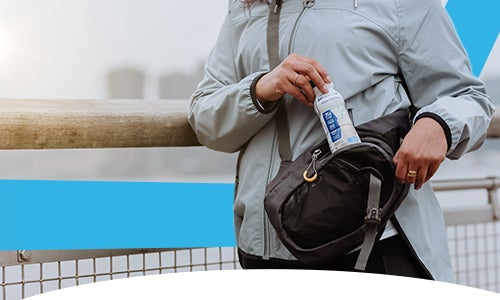Image of a person putting an OPTIFAST drink into a bag