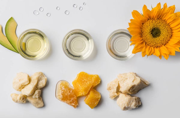 The natural ingredients, such as shea butter, beeswax & honey, that Burt's Bees use in their skincare laid out on a table