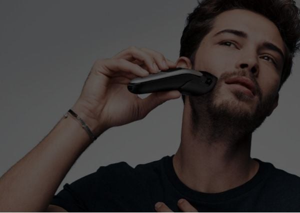 For Beards List Page Banner - man trimming his stubble beard with an Braun 10-in-1 All-in-one Trimmer 7 MGK7220 with attachment