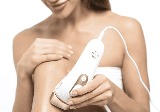 Permanent - Braun - shot of woman in towel using silk-expert pro 5 IPL to remove hair from legs