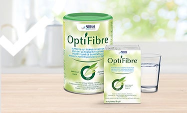 Optifibre products on wooden table with glass of water
