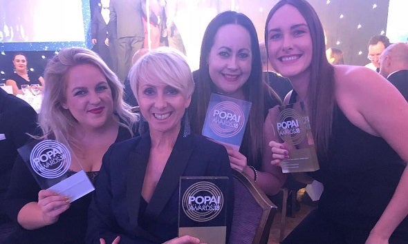 Revolution Beauty team holding POPAI Awards 2018