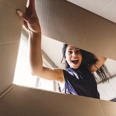 Woman looking excitedly into her Coca-Cola bundle box