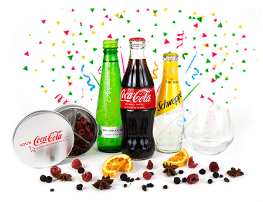 An array of Schweppes and Coca-Cola products surrounded by confetti