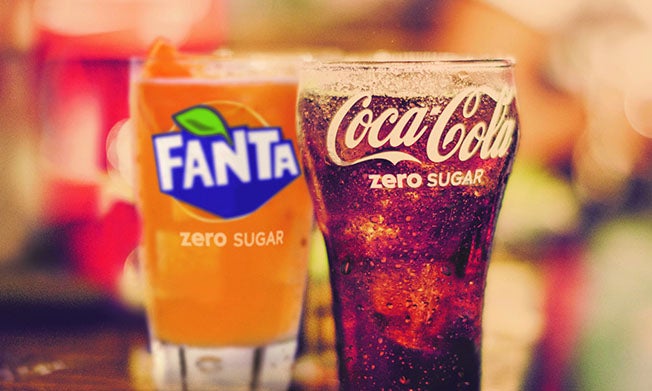 Glasses of cold Fanta Zero Sugar and Coca-Cola Zero Sugar