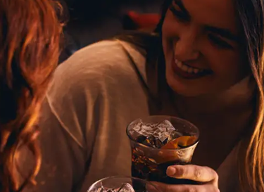 Two people drinking alcoholic beverages