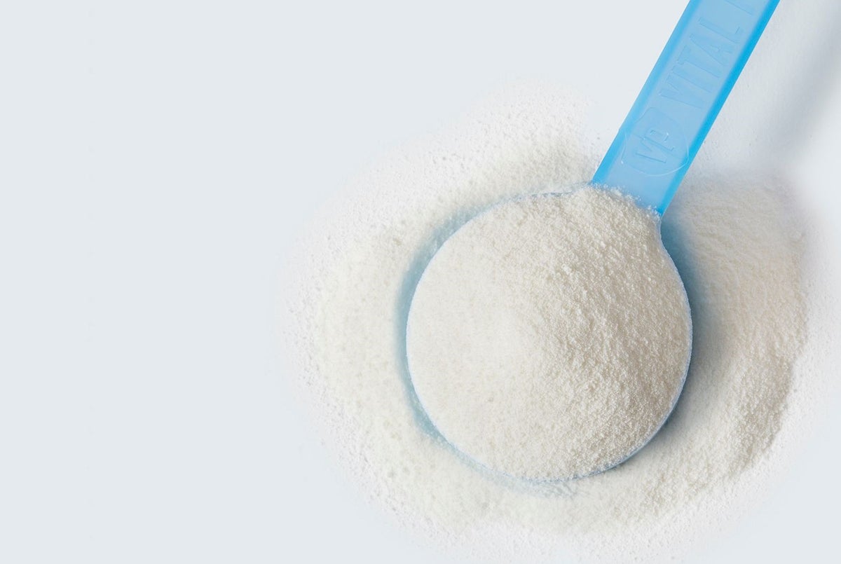 scoop of collagen peptides powder with white background