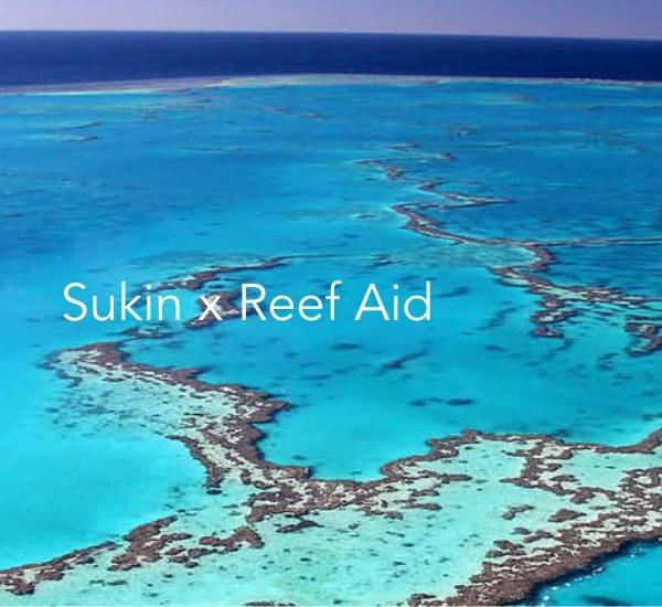 Sukin x Reef Aid text on reef sea background banner