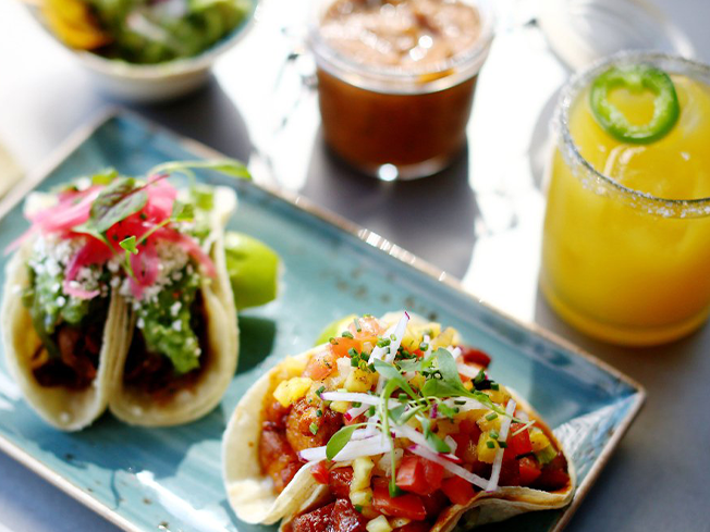 Plate of soft tacos with drinks