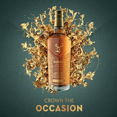A bottle of Glenfiddich Grand couronne is present with a pop of golden shapes in the background, text reads: 'skilfully crafted, enjoy responsibly'