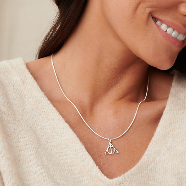women-smiling-while-wearing-harry-potter-themed-necklace