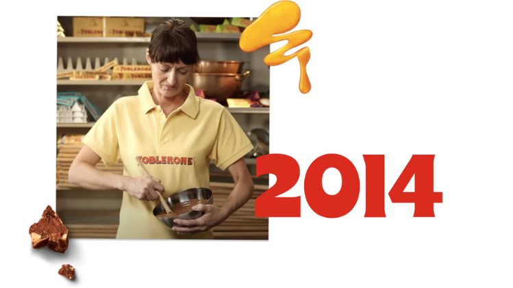 A picture of a woman mixing chocolate with the year 2014 in red next to it.