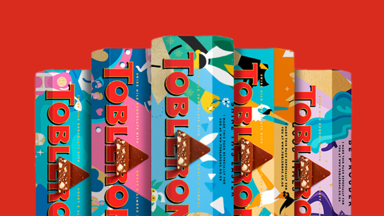 5 different packaged Toblerone bars in front of a red background.