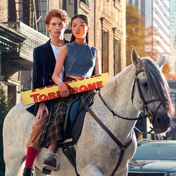 Poster image of some truly individuals carrying a giant Toblerone on horseback