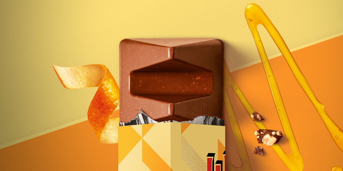 Opened Orange Toblerone Bar sitting on orange surface with an orange peel