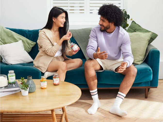 two people on the sofa consuming nature's truth products