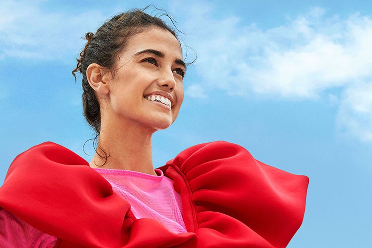 A young woman smiling.