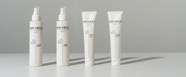 Two models holding skin virtue products