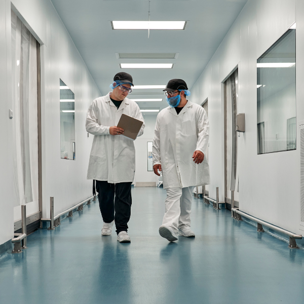 Two scientist walking down a hallway