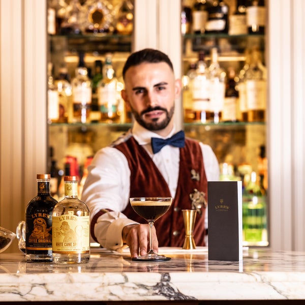 Barman serving an espresso martini with lyre's products