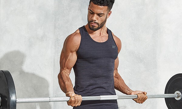 Athletic man doing a barbell curl