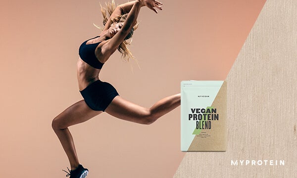 A woman doing a yoga pose in the air with the vegan protein blend protein powder bag featured by Myprotein.