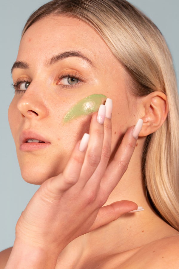 woman applying exfoliating scalp scrub to her scalp