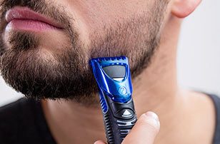 Man trimming beard with Gillette Styler.