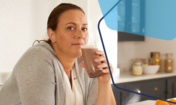Sign Up to OPTIFAST newsletter. A woman drinking a meal replacement shake.