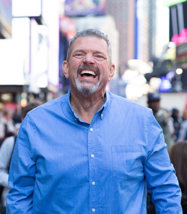 Image of a man laughing in a city