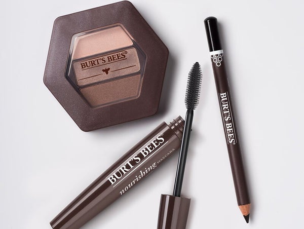 A Burt's Bees Eyeshadow Trio, Nourishing Eyeliner and Nourishing Mascara laid out on a table