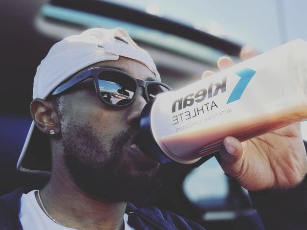 Rest and recovery. A man drinking a shake with recover supplements powder.