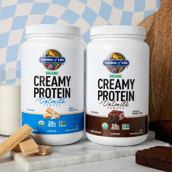 Garden of Life Creamy protein with oat milk in vanilla cookie and chocolate brownie flavour on a kitchen countertop