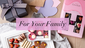 For your family in black text, set against a pink background, with a selection of chocolates in the background.