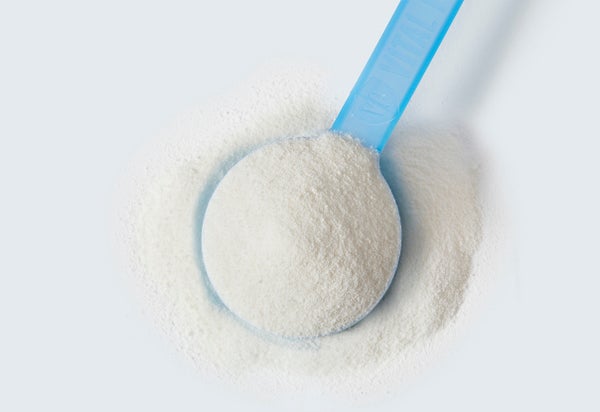 A blue scoop filled with collagen powder.